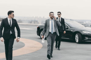 businessman walking with bodyguards